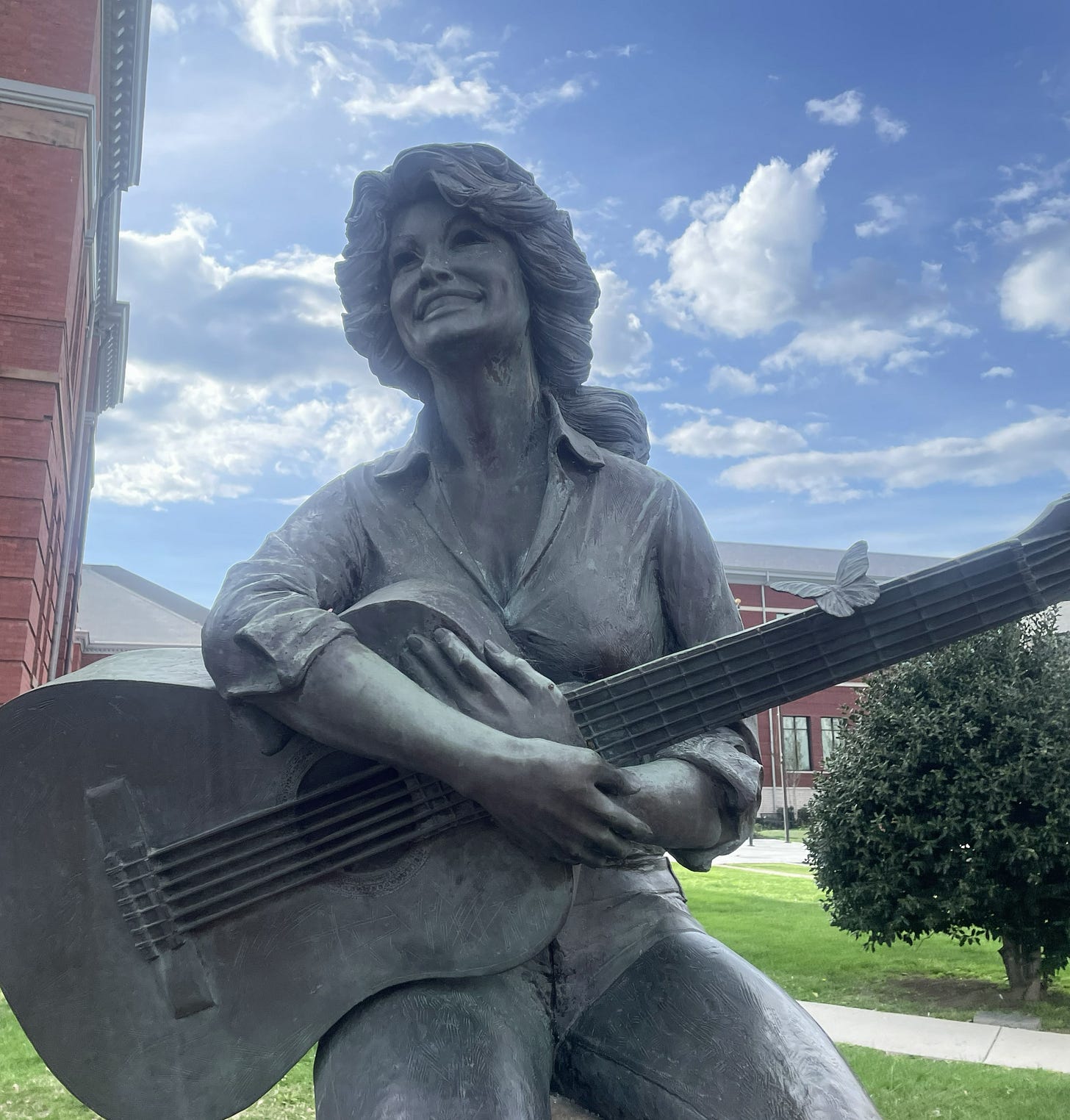 Statue of dolly Parton holding a guitar in Sevierville, Tennessee Statue of dolly Parton holding a guitar in Sevierville, Tennessee