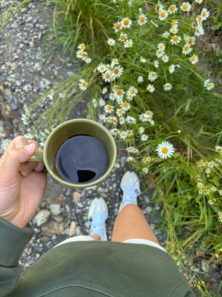 girl outdoors with coffee in hand