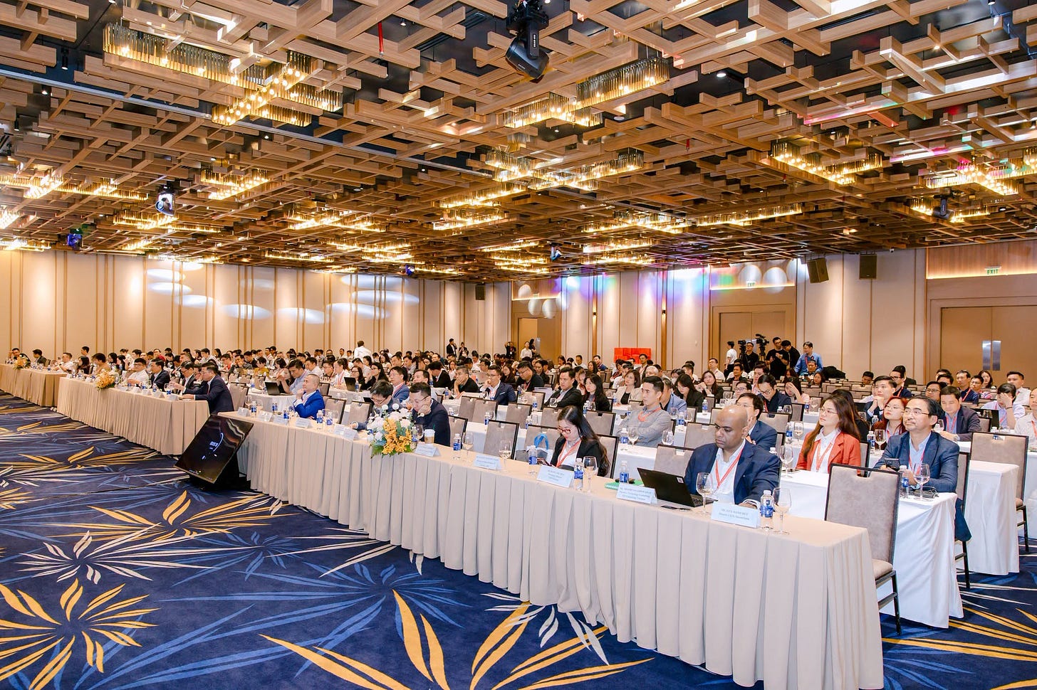 May be an image of lighting, table, dais and crowd