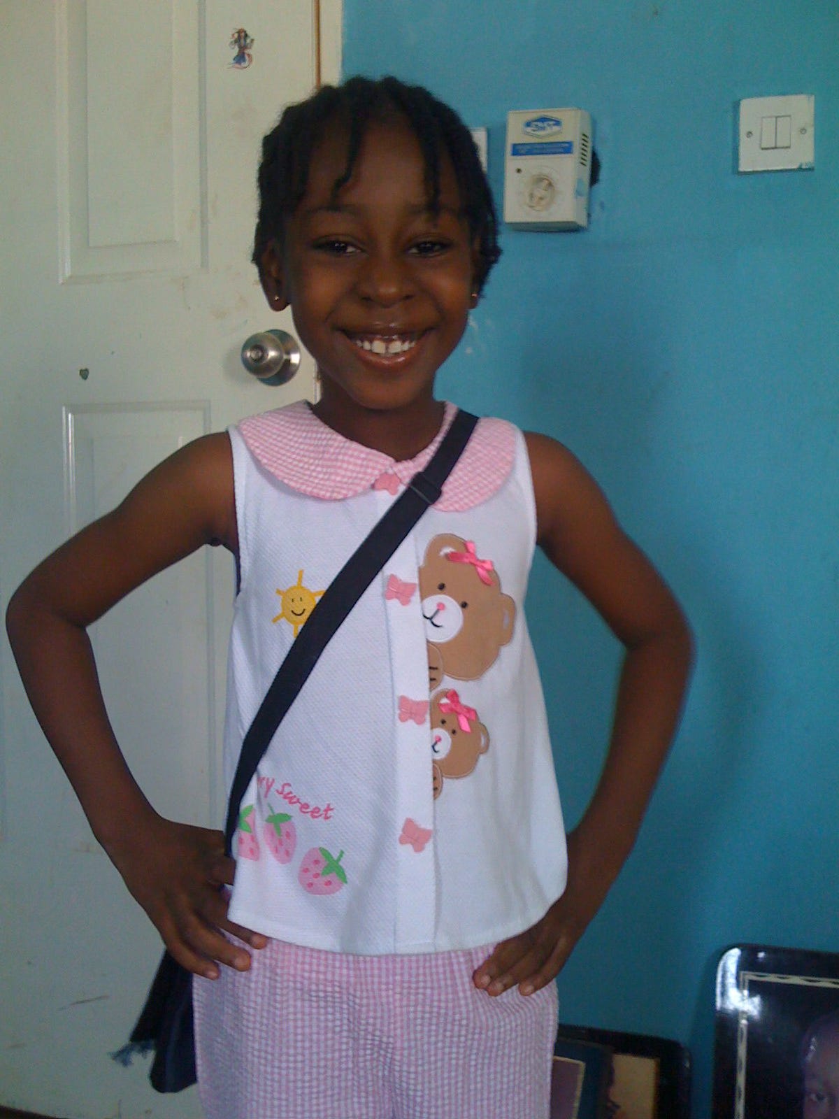 Picture of the author at eight, smiling at the camera with hands on hips