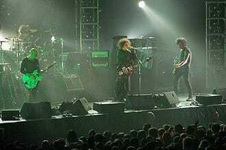 The Cure performing in August 2007. From left to right: Jason Cooper, Porl Thompson, Robert Smith, and Simon Gallup