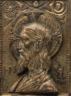 Bronze sculpture of a profile of Christ with angels above his head.