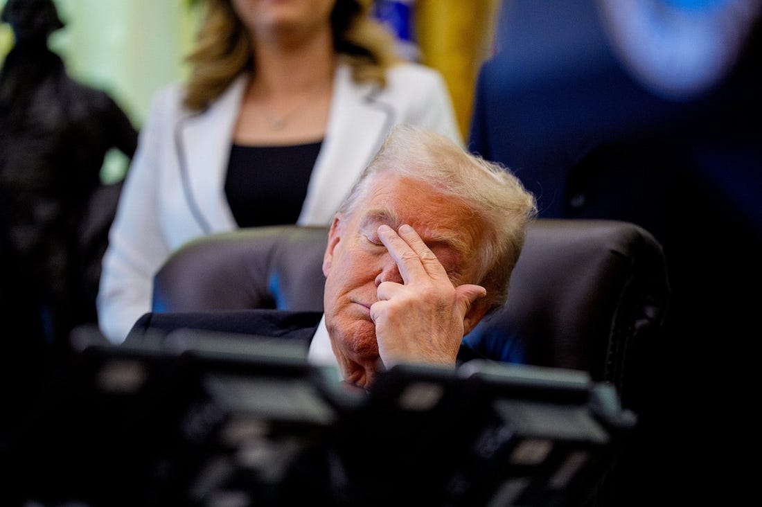 President Trump touches his face with his eyes closed while appearing at an event