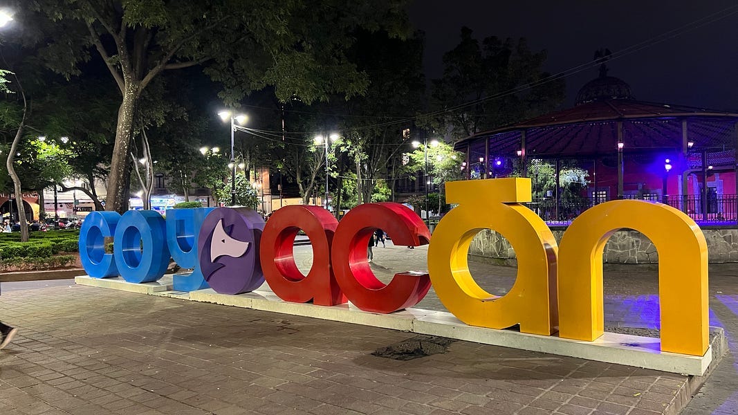 Multicolored letters in plaza spelling Coyaocan in a Mexico City neighborhood plaza.