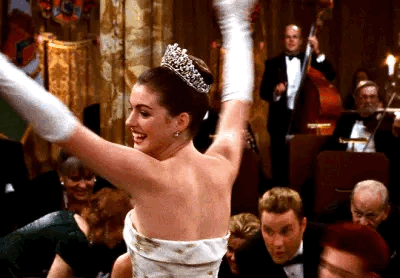 This may contain: a woman in a white dress and tiara is dancing with other people behind her