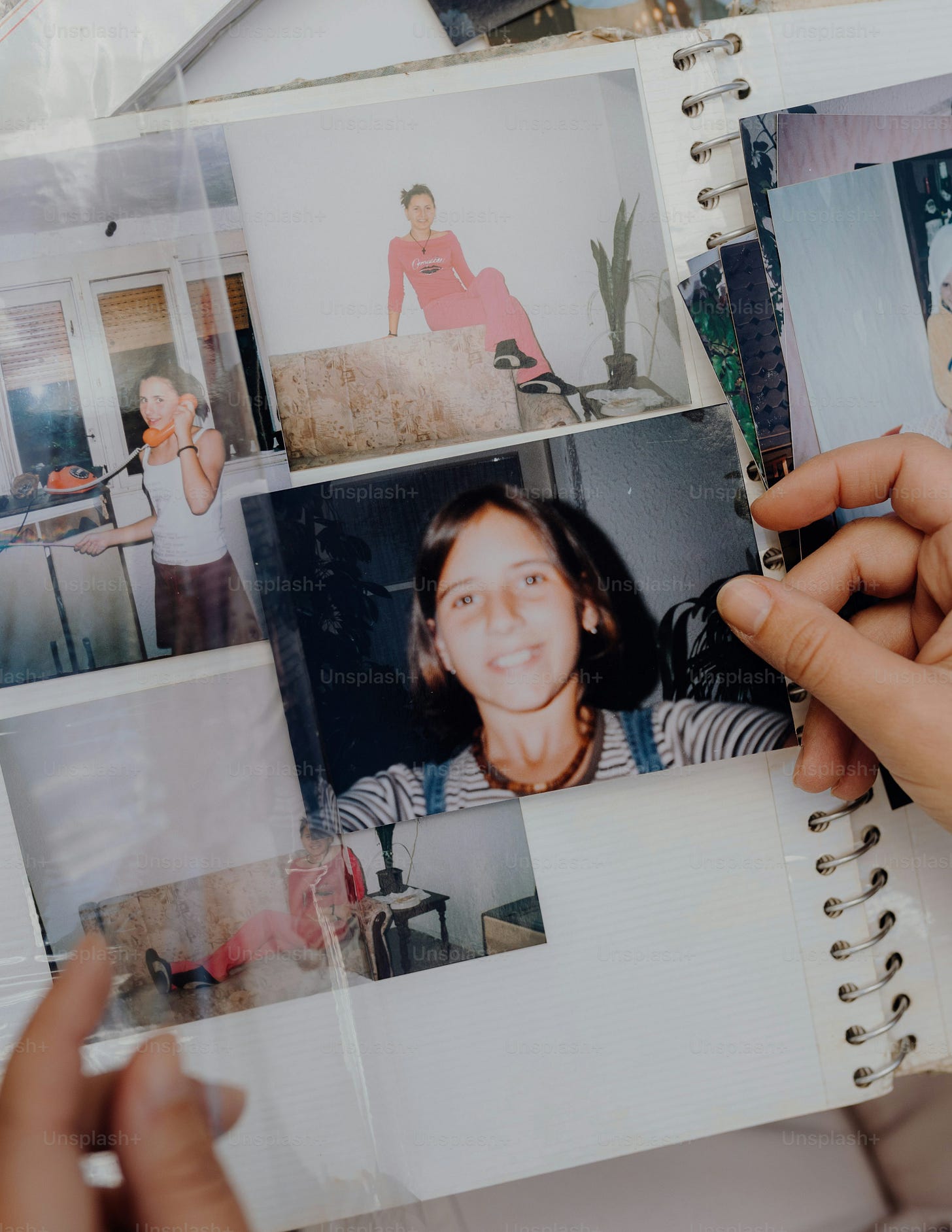 a person holding a book with pictures of people on it a person holding a book with pictures of people on it