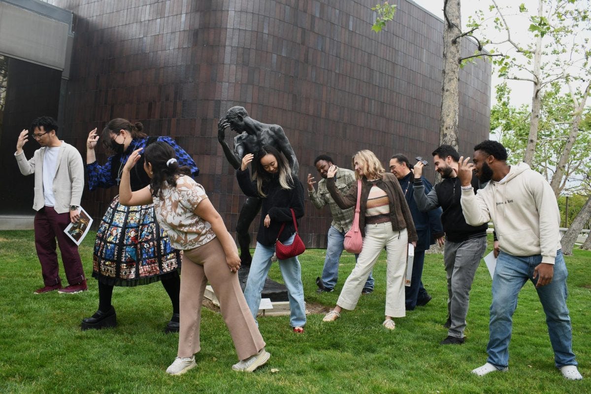 (L-R) Anthropology major Zion Kim, 22; anthropology major Jamie Chappell, 27; history and anthropology major Leslie Andrade, 23; anthropology major Suki Yuhaku, 20; anthropology major Tanner Hatchett, 23; art history professor Karen Whitney; anthropology professor Lawrence Ramirez; philosophy professor Roberto Garcia and studio arts major Jordan Irby, 24, emulate the posture of artist Auguste Rodin's "Pierre de Wissant (nude)" sculpture outside the Norton Simon Museum in Pasadena on Friday, April 25. Six students and three professors attended the trip to the museum, which was organized by the El Camino College Anthropology Club. (Nikki Yunker | The Union)