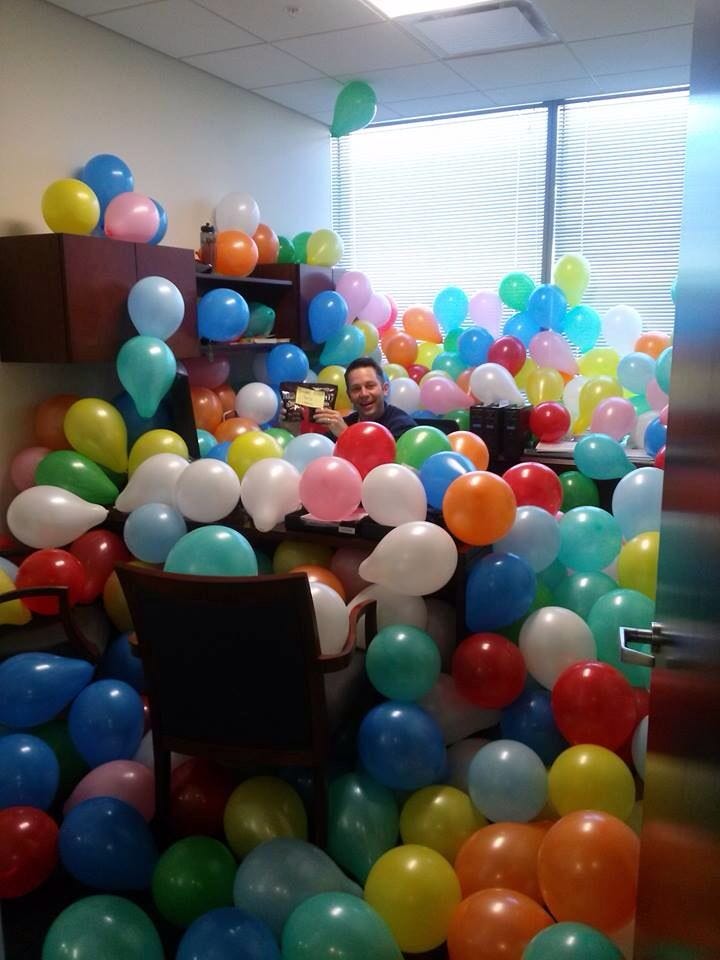 This may contain: a room filled with lots of balloons floating in the air