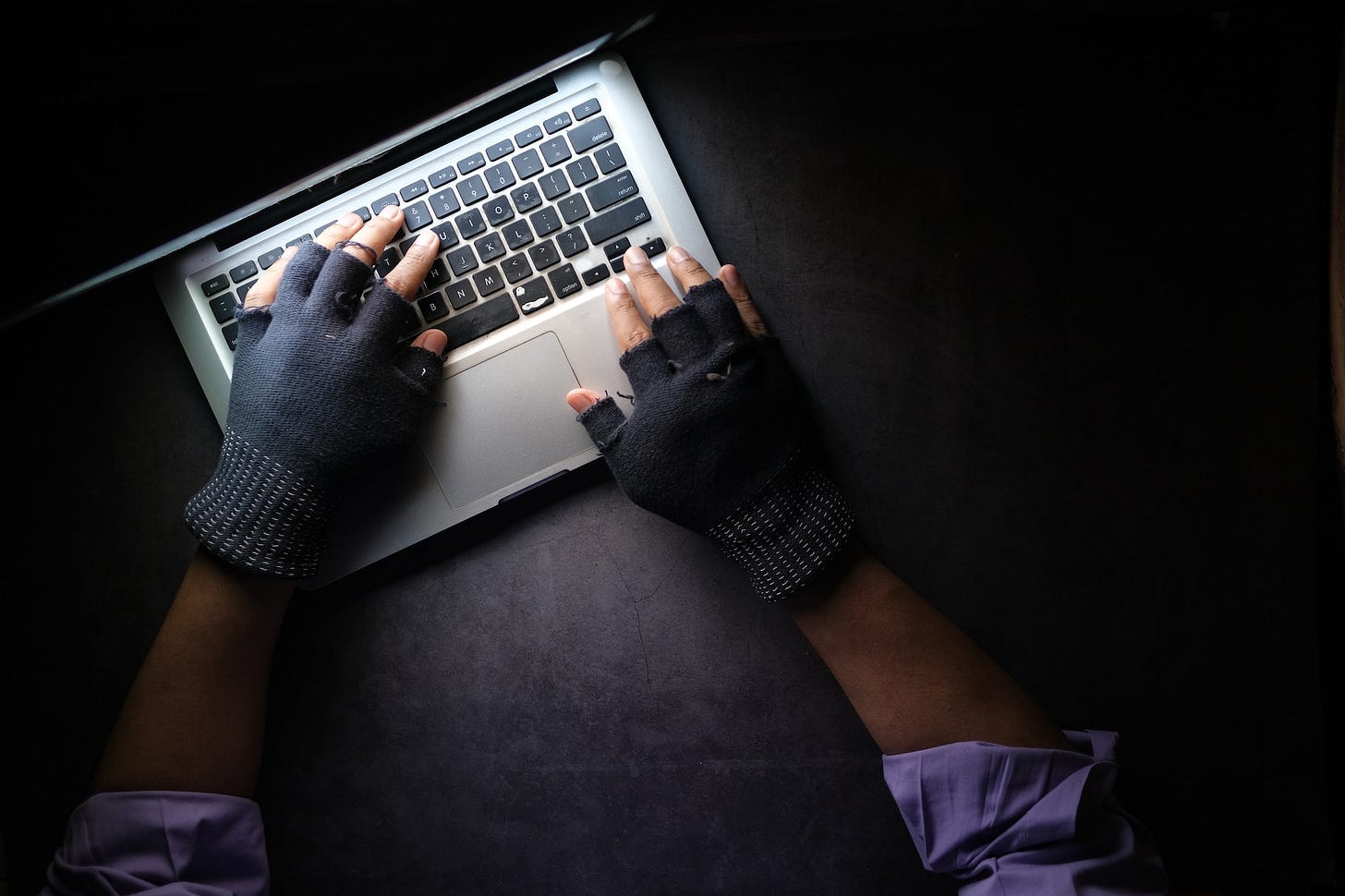 person in black long sleeve shirt using macbook pro person in black long sleeve shirt using macbook pro