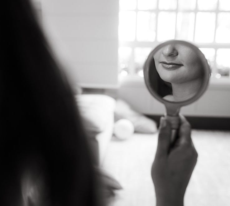 a woman holding a hair dryer in front of her face