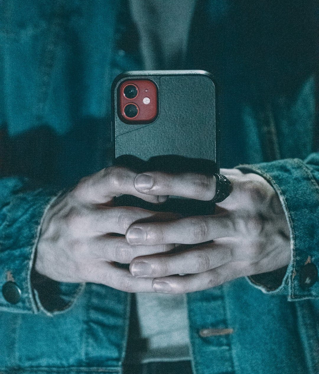 a person holding a cell phone in their hands