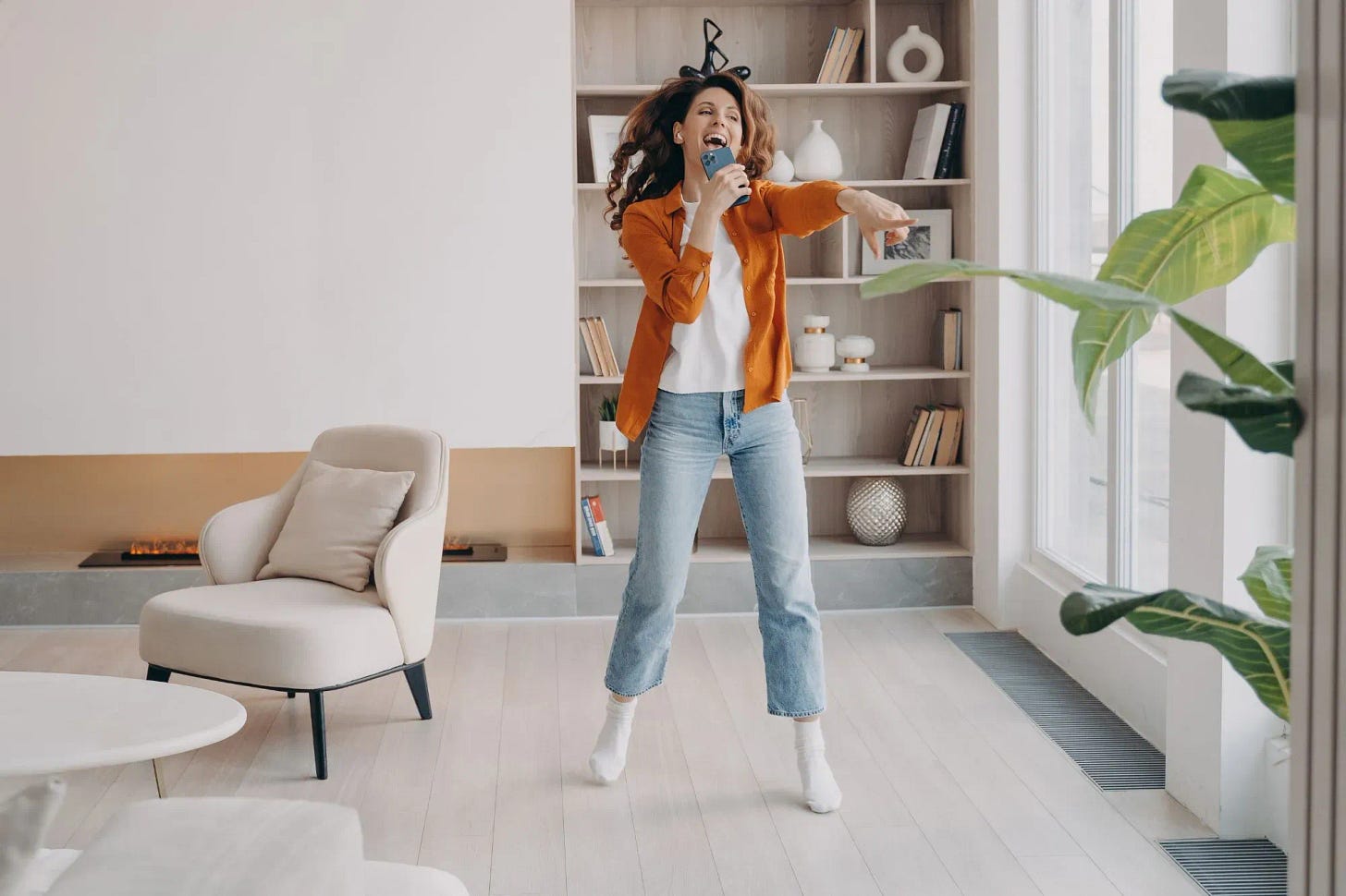 A young woman singing and having fun while at work break