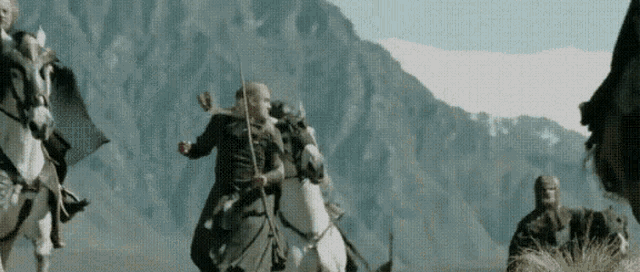Actor Orlando Bloom as Legolas impossibly front mounts a galloping horse while riding to battle - from the 2002 film The Lord of the Rings: The Two Towers directed by Peter Jackson