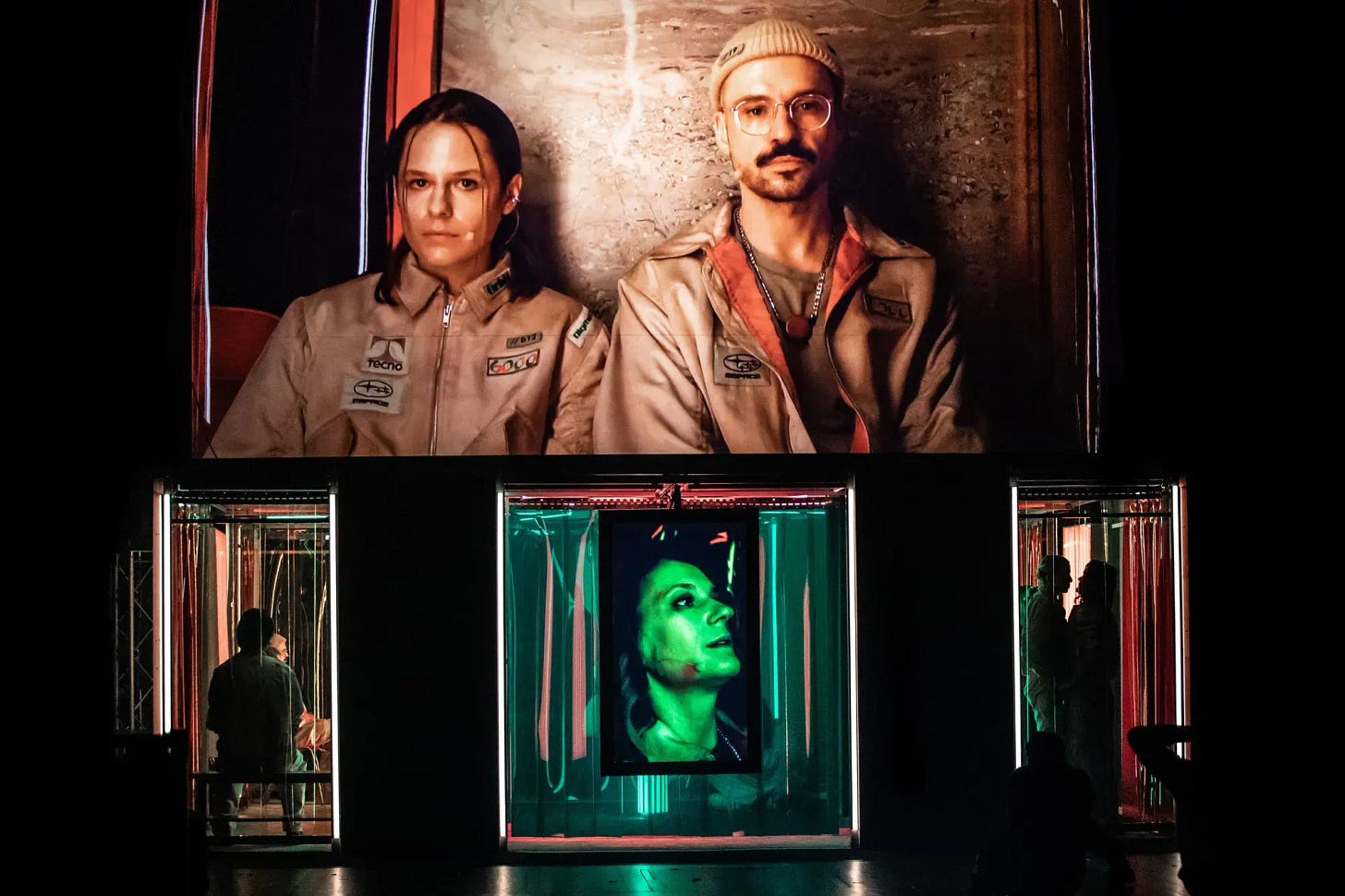 A photograph of The Employees showing a man and a woman and three might-up boxes