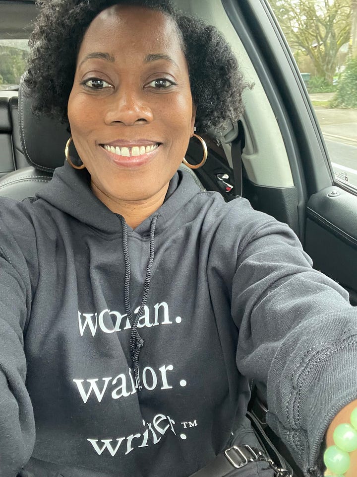Renee Simms in a black Woman. Warrior. Writer. hoodie (left), Woman. Warrior. Writer. White T-Shirt (right)
