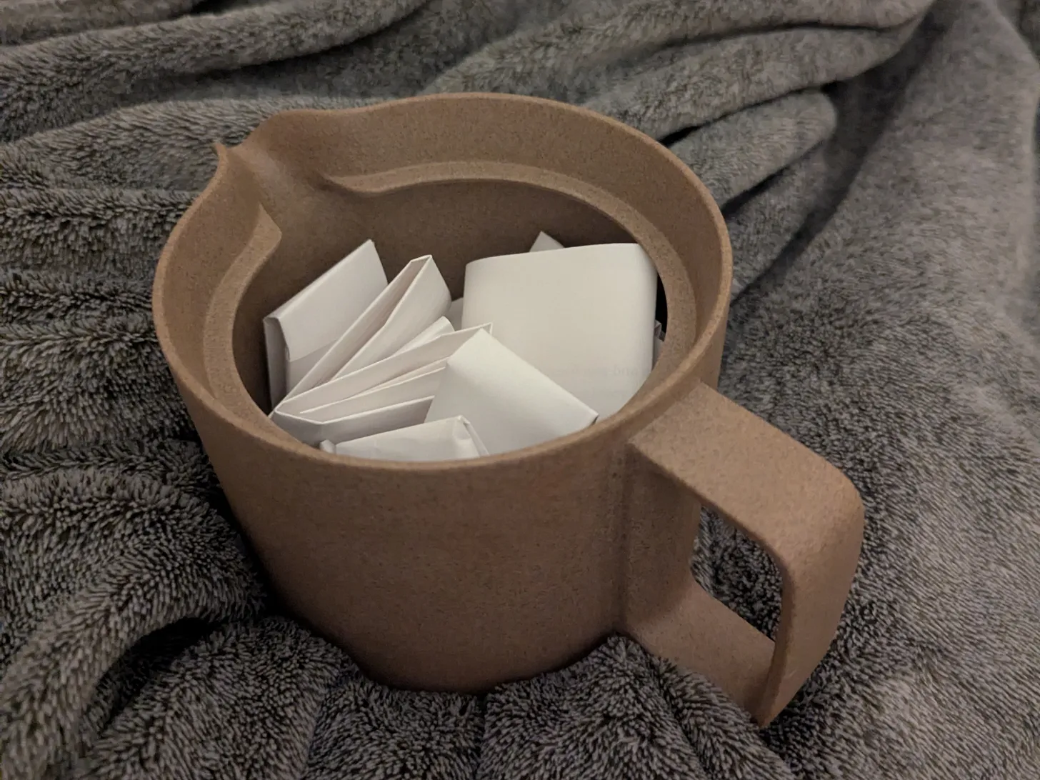teapot full of folded papers