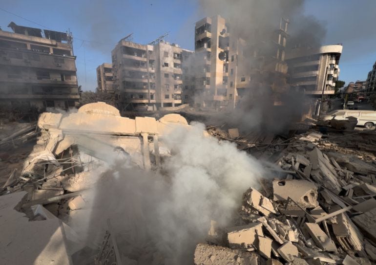 Smoke rises from a destroyed building that was hit by an Israeli airstrike in Dahiyeh Smoke rises from a destroyed building that was hit by an Israeli airstrike in Dahiyeh
