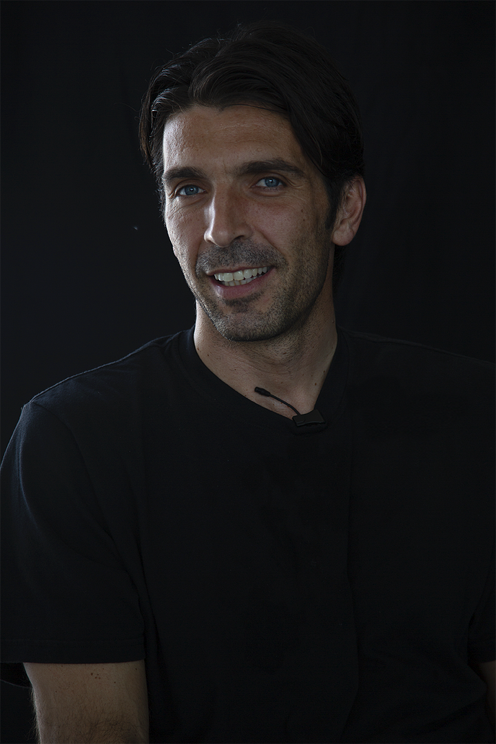 Gianluigi Buffon during an interview, shown in four portraits against a black background: smiling, speaking, in profile with a serious expression, and gesturing mid-sentence.