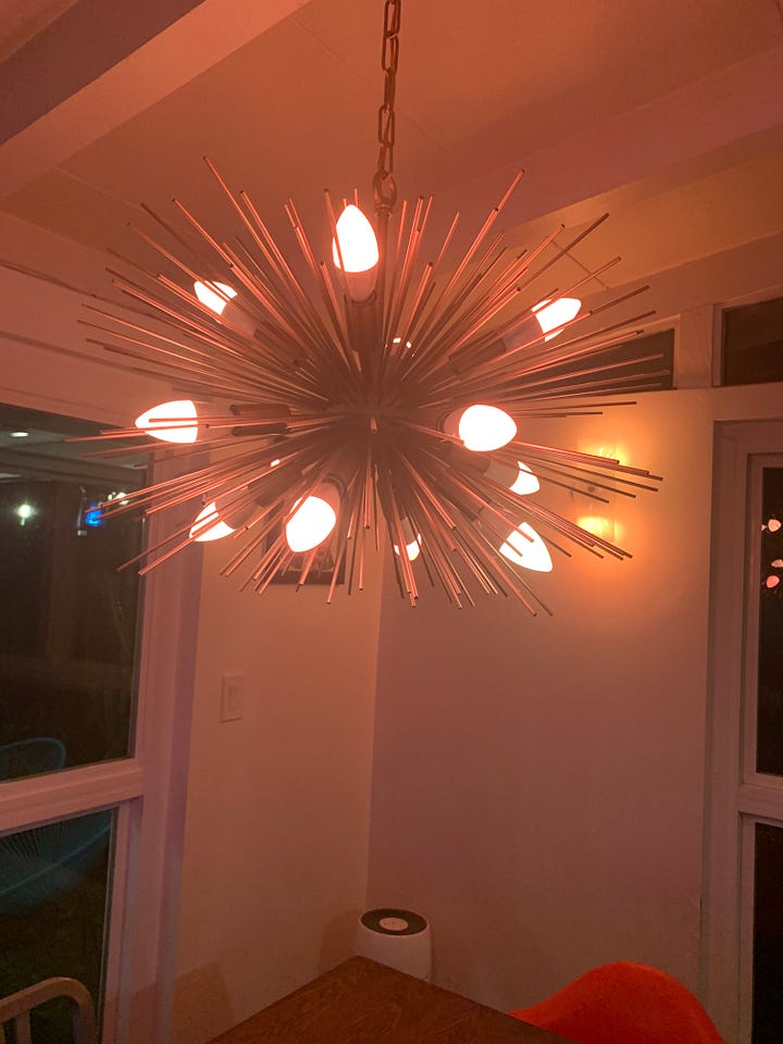 Caissie’s Sputnik chandelier with white bulbs, then pink bulbs, then blue bulbs, then multicolored bulbs.