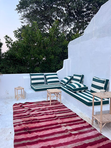 an image of a man weaving a red rug, a picture of me talking to the lady from Valencia about the rugs in warehouse, a picture of a the white rooftop at maison maggie with a red stripe rug and green stripe bench