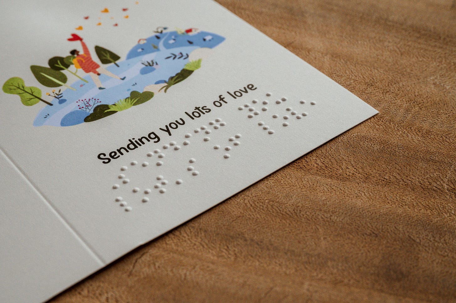 A greeting card that reads 'sending you lots of love' in both English and braille.