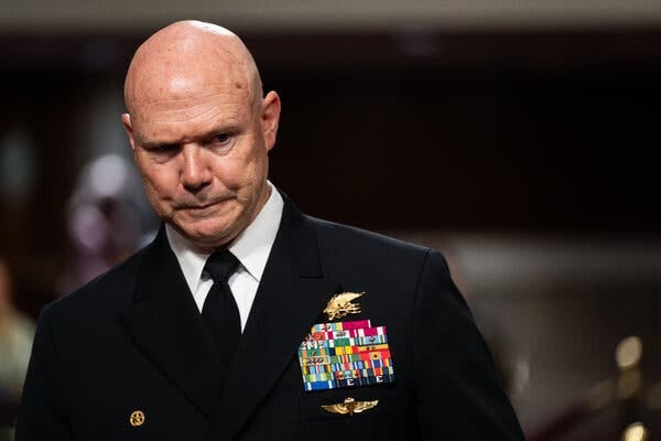 Admiral Frank Mitchell Bradley, wearing his dress uniform, stands in a congressional hearing room.