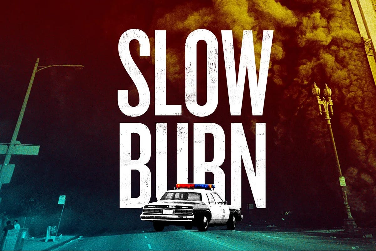 A picture of a police car in Downtown Los Angeles engulfed by smoke, with the title "SLOW BURN" superimposed over it