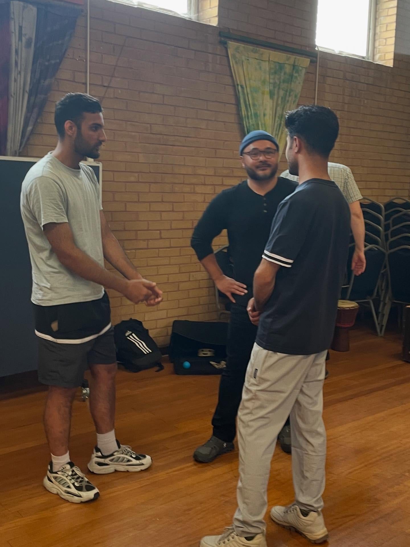 May be an image of 3 people and people playing basketball