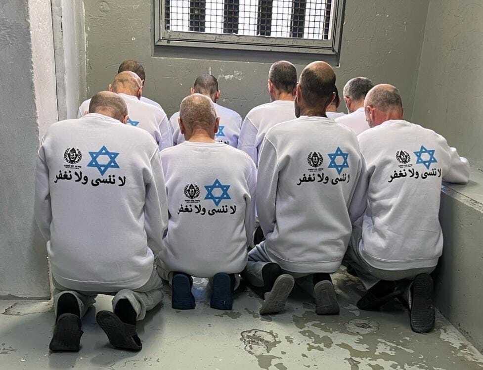 Palestinian prisoners set for release in IPS shirts featuring its logo, a Star of David and the sentence in Arabic: ‘We will not forget or forgive,’ Feb. 15, 2025. (Israel Prison Service) Palestinian prisoners set for release in IPS shirts featuring its logo, a Star of David and the sentence in Arabic: ‘We will not forget or forgive,’ Feb. 15, 2025. (Israel Prison Service)