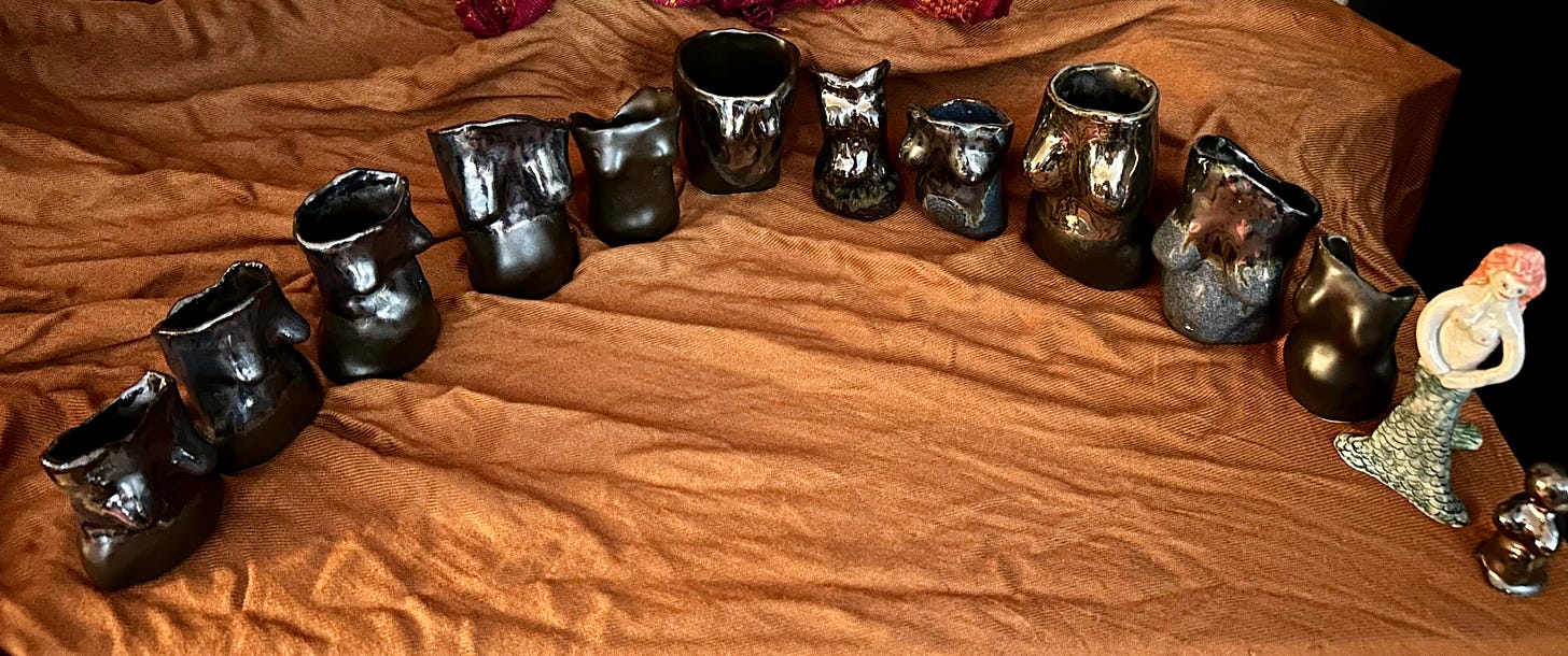 a display of small ceramic goddess figures in a semicircle