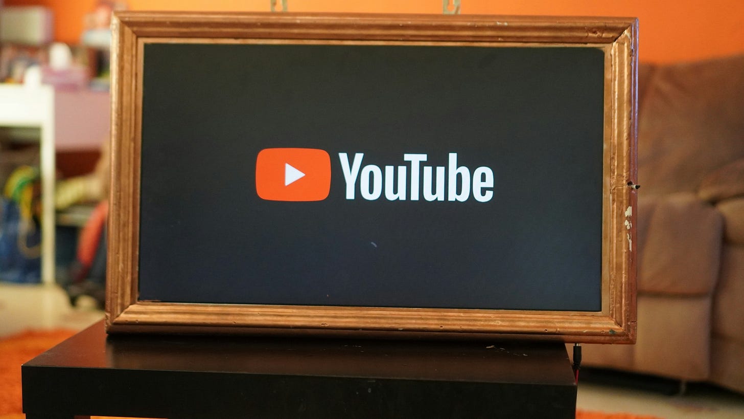 A picture frame sitting on top of a table. The YouTube logo is inside the frame.