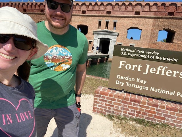two people in front of the Dry Tortugas National Park sign