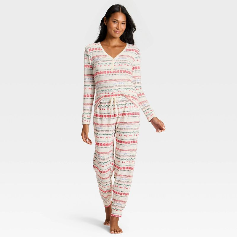 White colored pajama set with red and green patterns, featuring a long-sleeve top and drawstring pants.