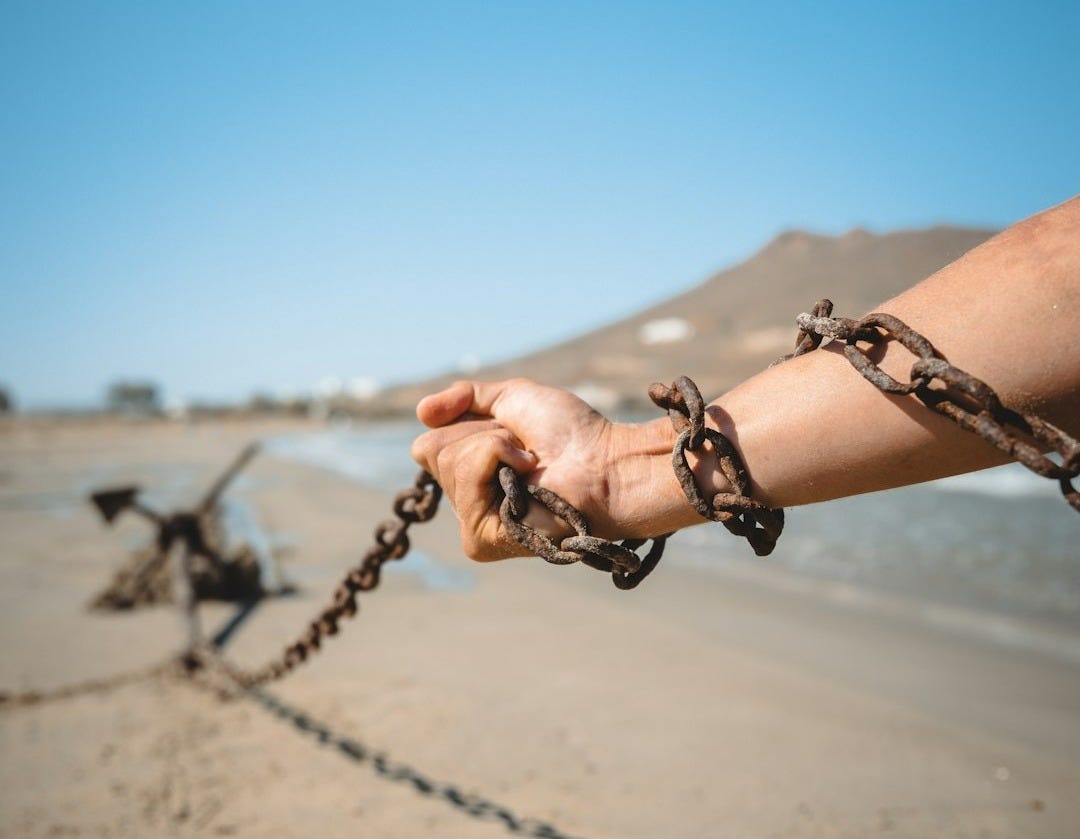 a person holding a chain on a beach a person holding a chain on a beach
