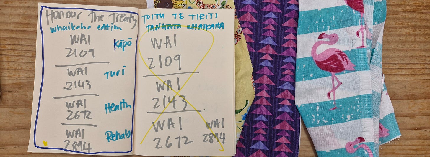 notebook and textiles. text in notebook reads, Honour the Treaty, WAI 2109, WAI 2143, WAI 2672, WAI 2894