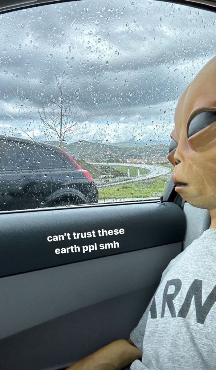 This may contain: an alien head sitting in the driver's seat of a car This may contain: an alien head sitting in the driver's seat of a car