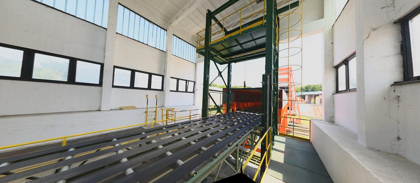 Rail-mounted crane and loading area between two industrial buildings Rail-mounted crane and loading area between two industrial buildings