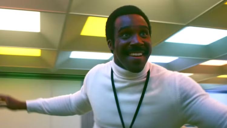 Seth Milchick in Season 1 of Severance, leading a dance experience.