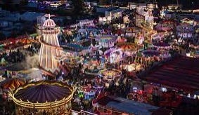 Helter Skelter and other fair rides lit up at night.