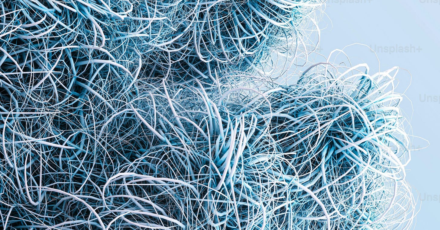 a bunch of blue yarn on a light blue background