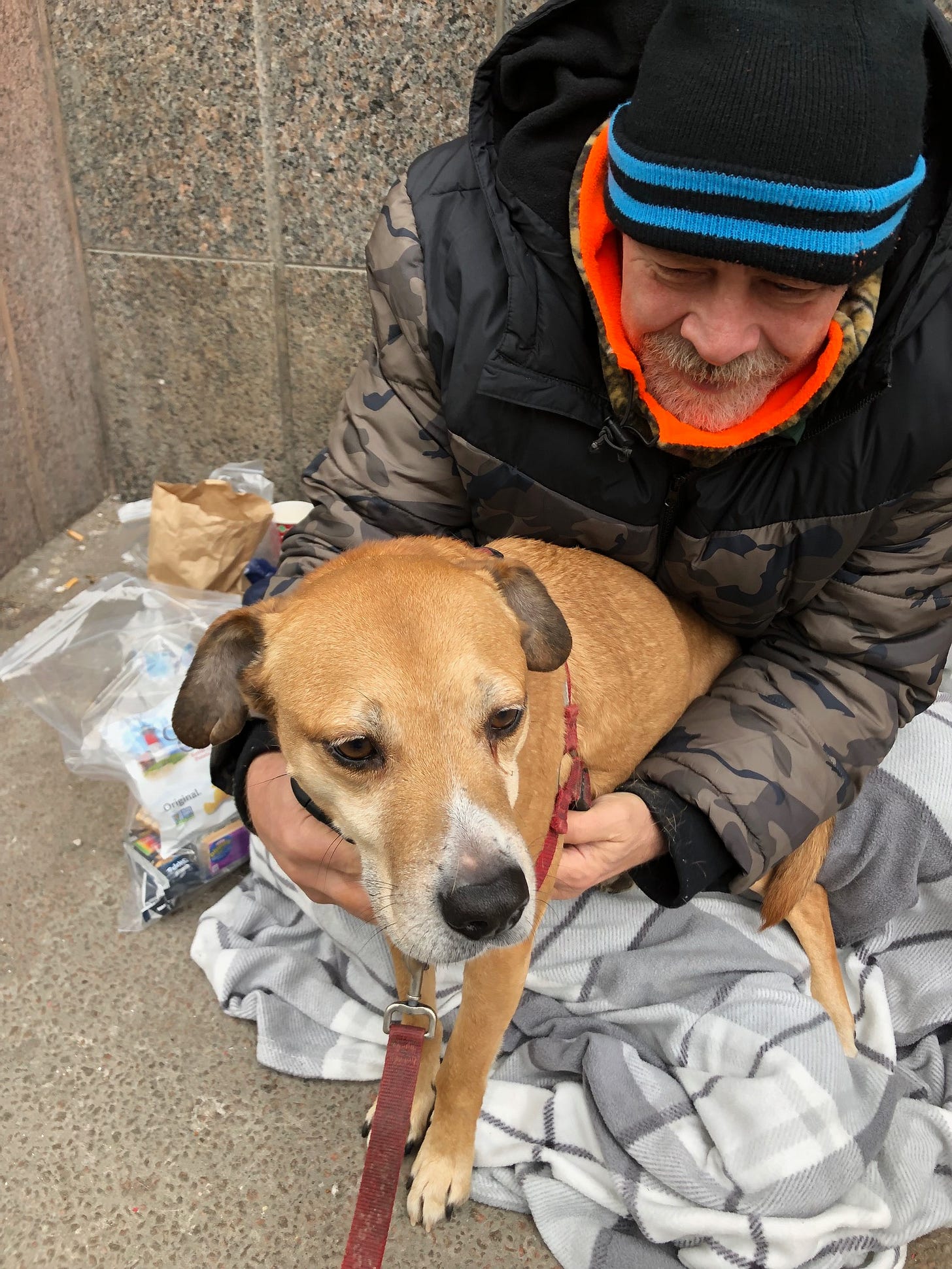 Street person petting a dog