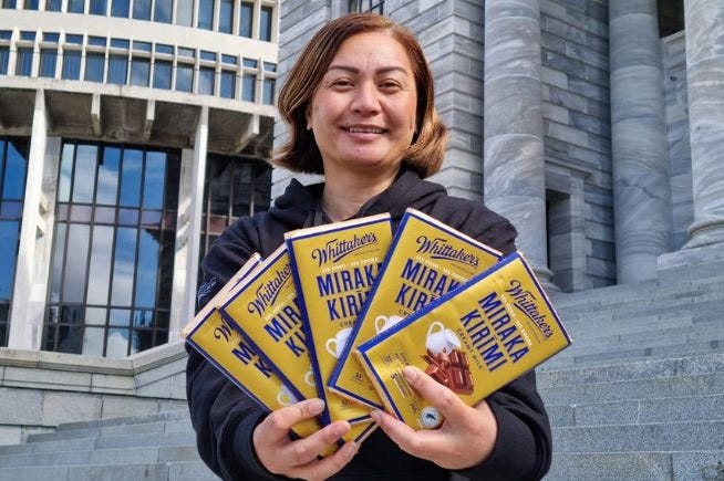 Marama Davidson with chocolate bars.