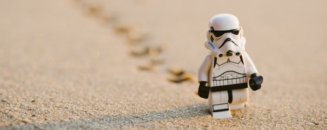 Stormtrooper minifigure walking on the sand Stormtrooper minifigure walking on the sand
