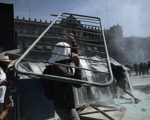 Protesters clash with police during a demonstration near the National Palace in Mexico City.