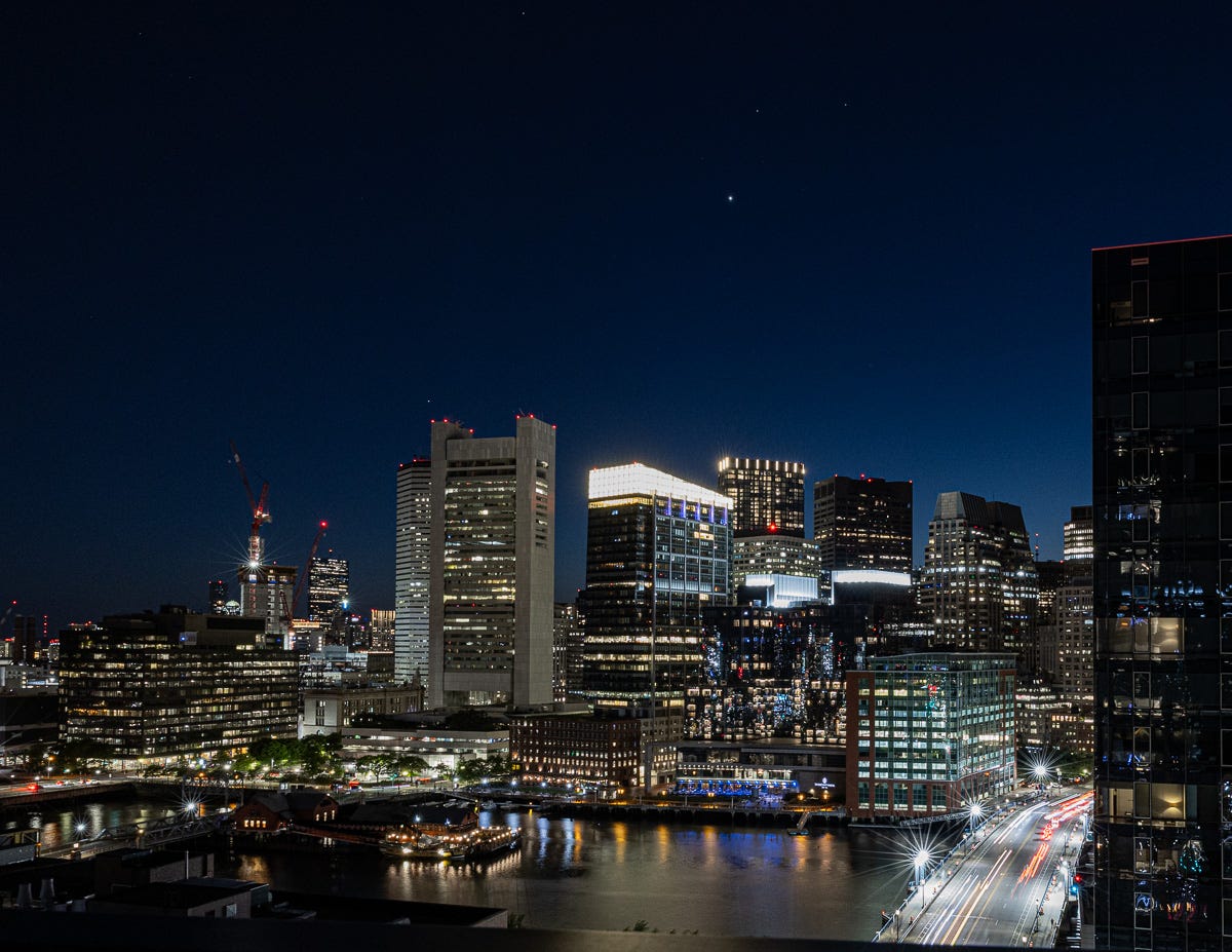 Photo of Boston at Night taken From 14th Floor Balcony in the Seaport.  Showing Stars and Twinkle Lights.