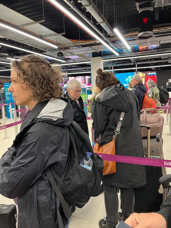 2025-6-25 Becky in ticket line at Edinburgh Airport, photo by author