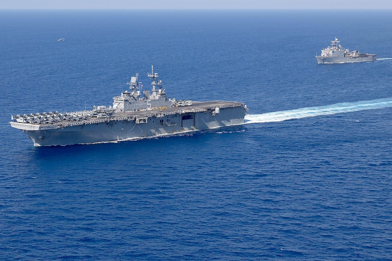 Two military ships move though the ocean. Two military ships move though the ocean.