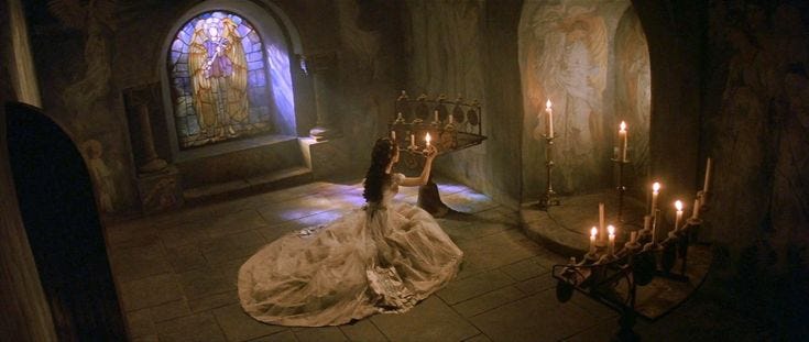 This may contain: a woman laying on the floor in front of candles