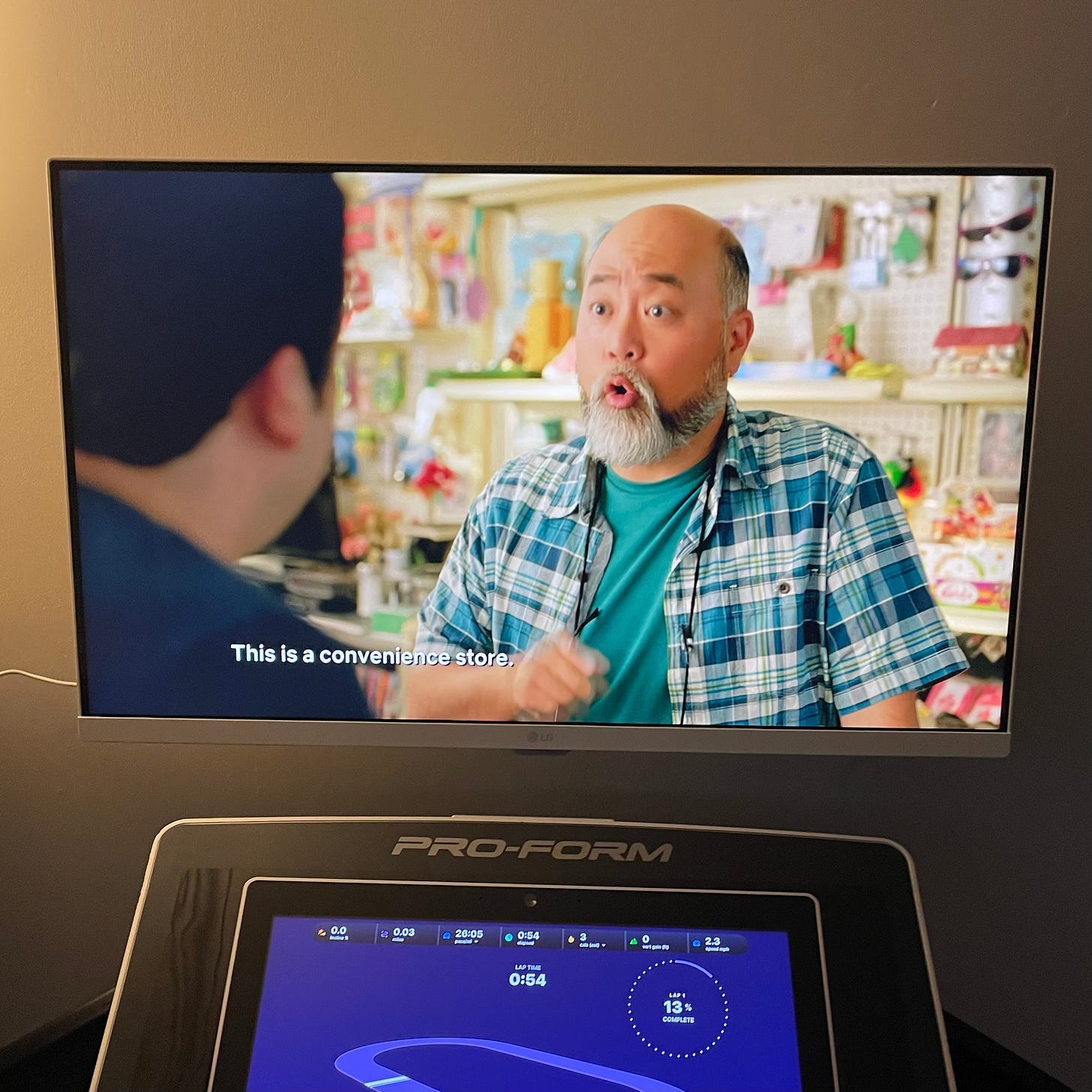 walking on treadmill, screenshot of kim's convenience on tv on wall