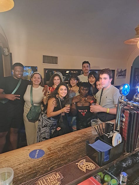 A negroni and a cup of water, my bar crawl group and a tip jar